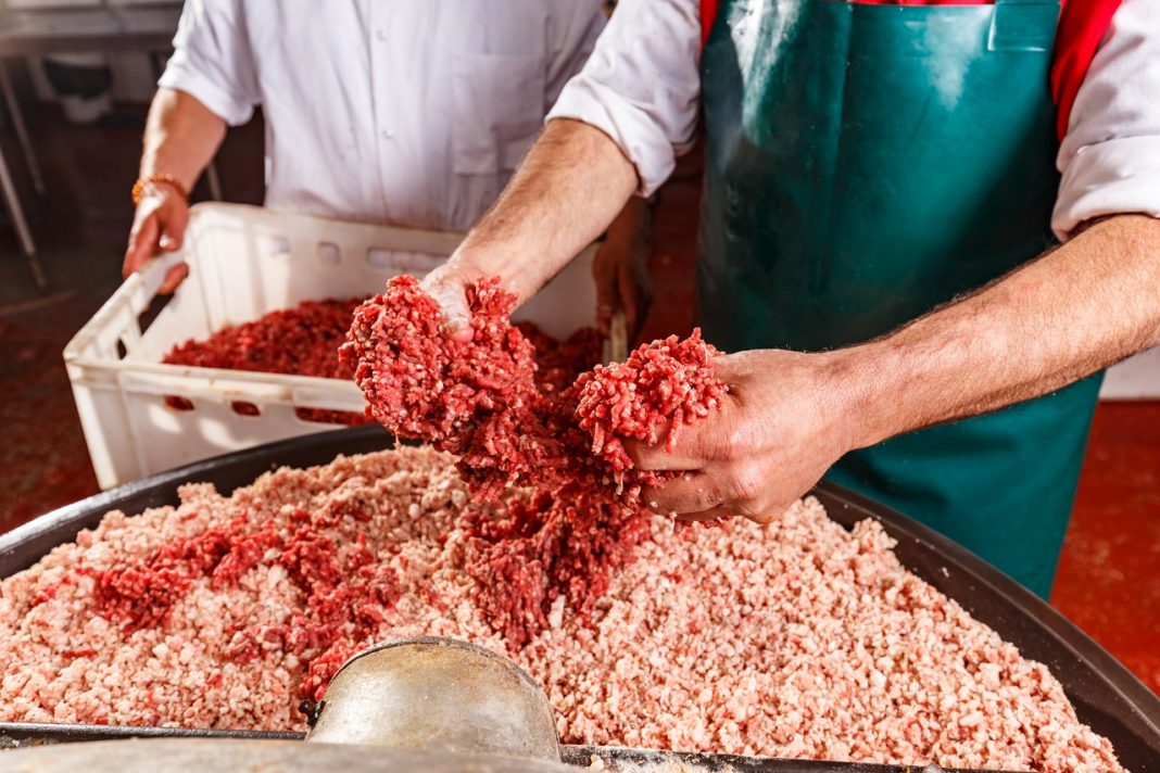 Butchers processing sausages