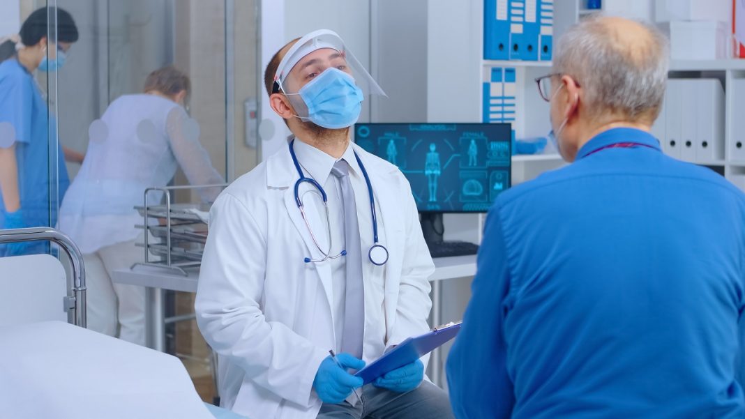 Doctor consulting patient during COVID 19