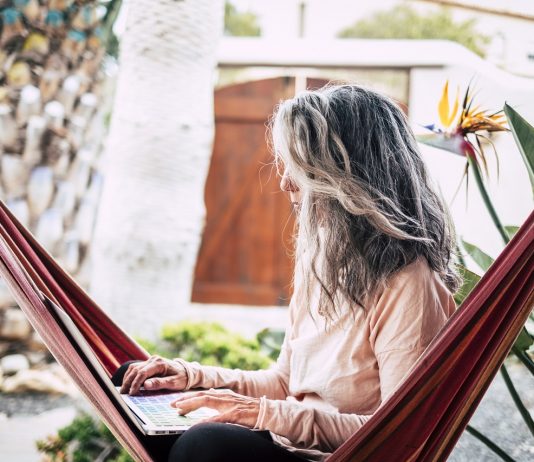 Smart work – a jövő munkájának új keretei Alternative modern adult people in smart working activity outdoo