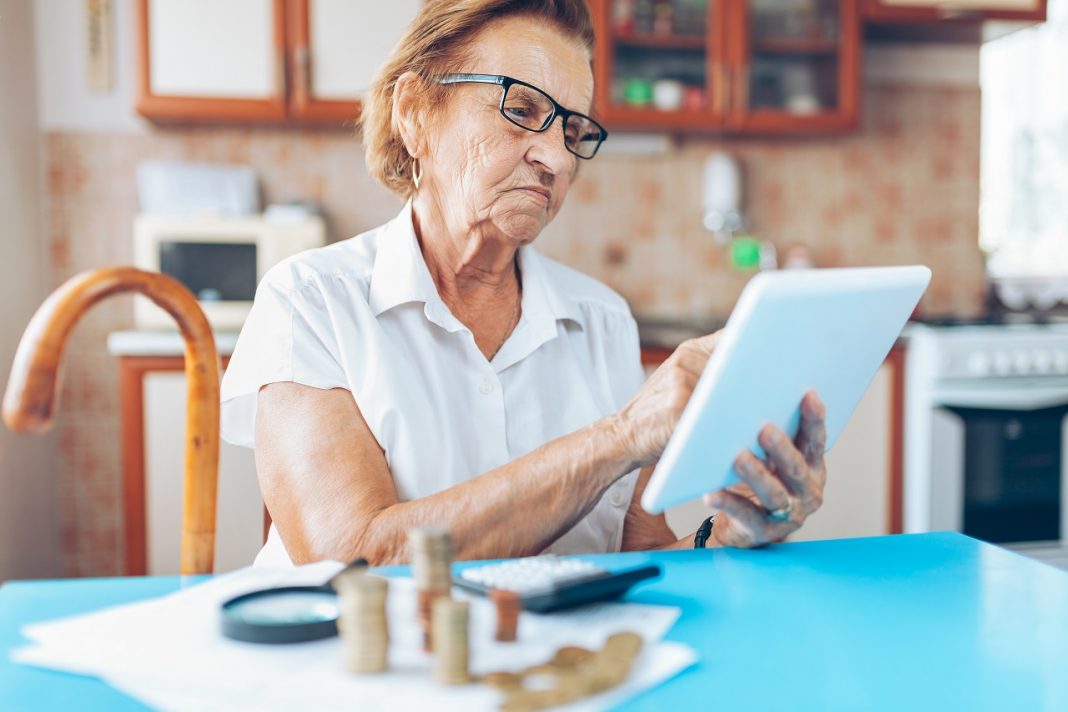 Senior woman checking her finances and invenstments
