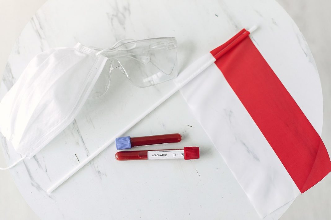 Coronavirus testing sample and Polish flag are on the table