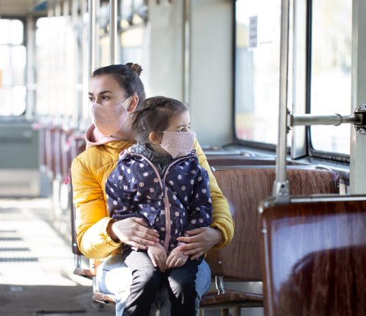 Április 8-ig meghosszabbították a védelmi intézkedések hatályát Mother and child in public transport, wearing masks . during a pandemic.