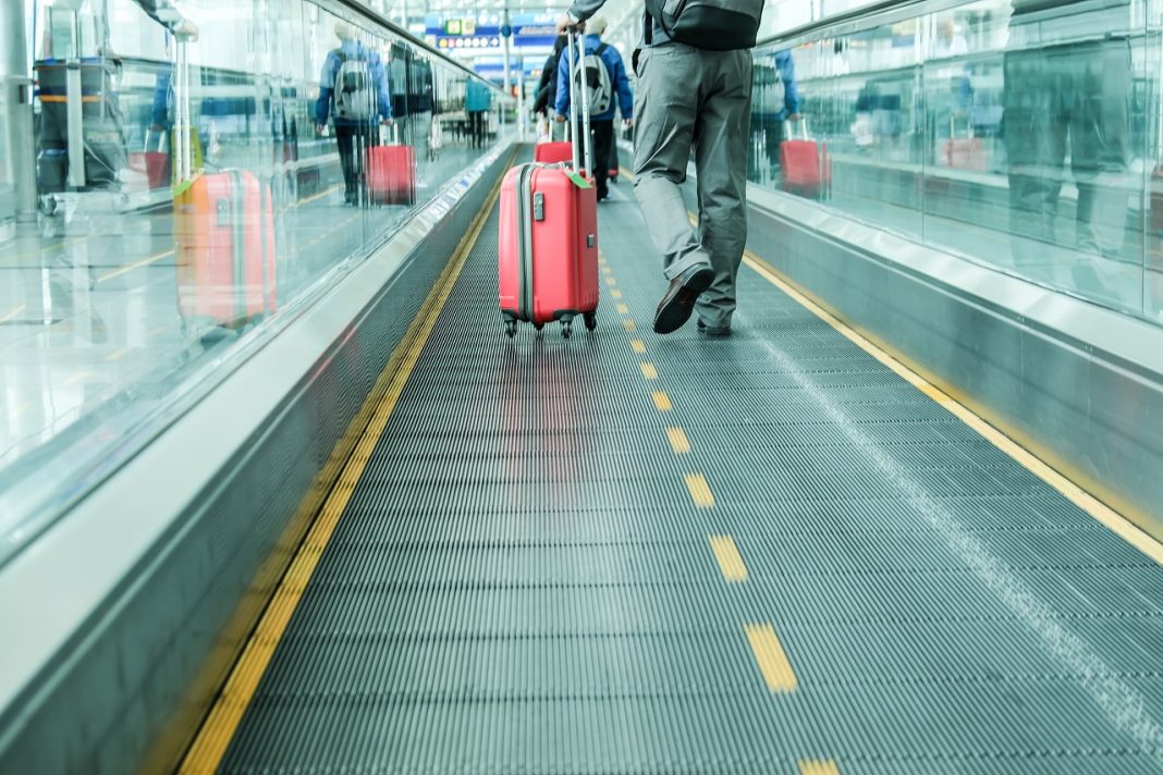 Passengers with bags on travelator