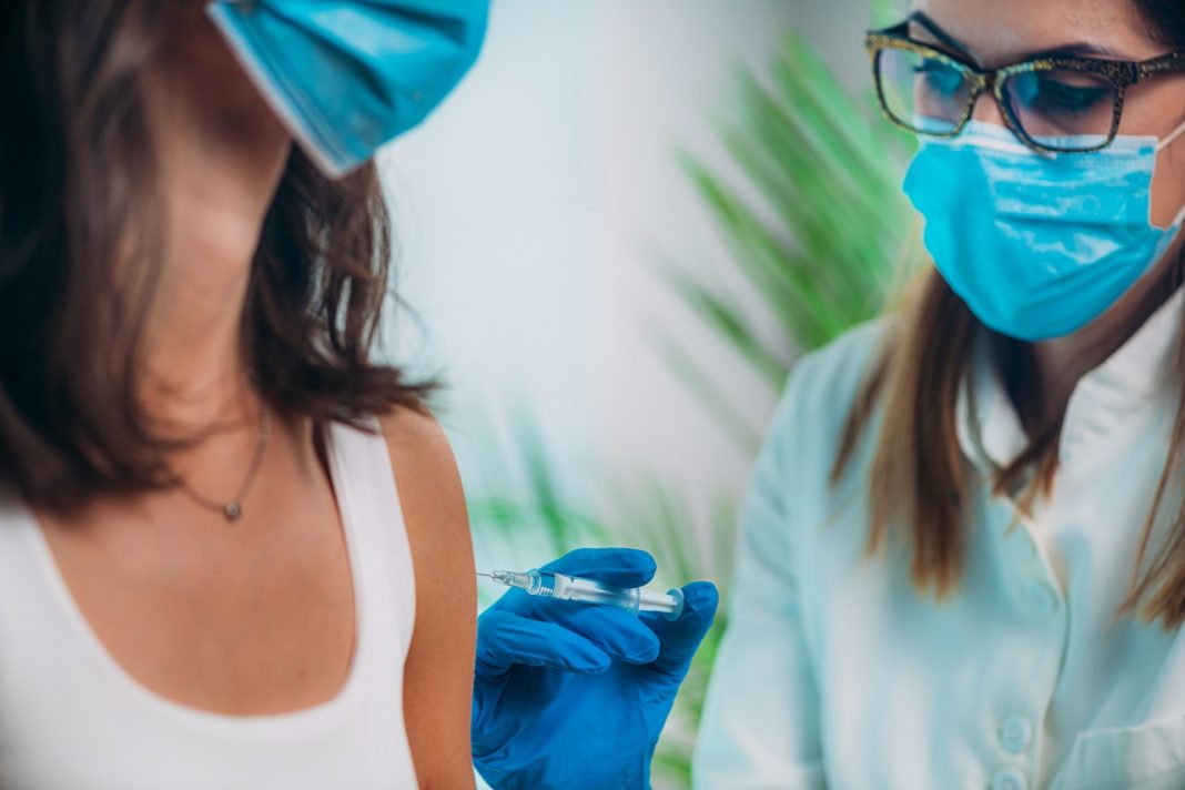 Woman Receives a Vaccination in the Doctor’s Office. Corona Virus Vaccination.