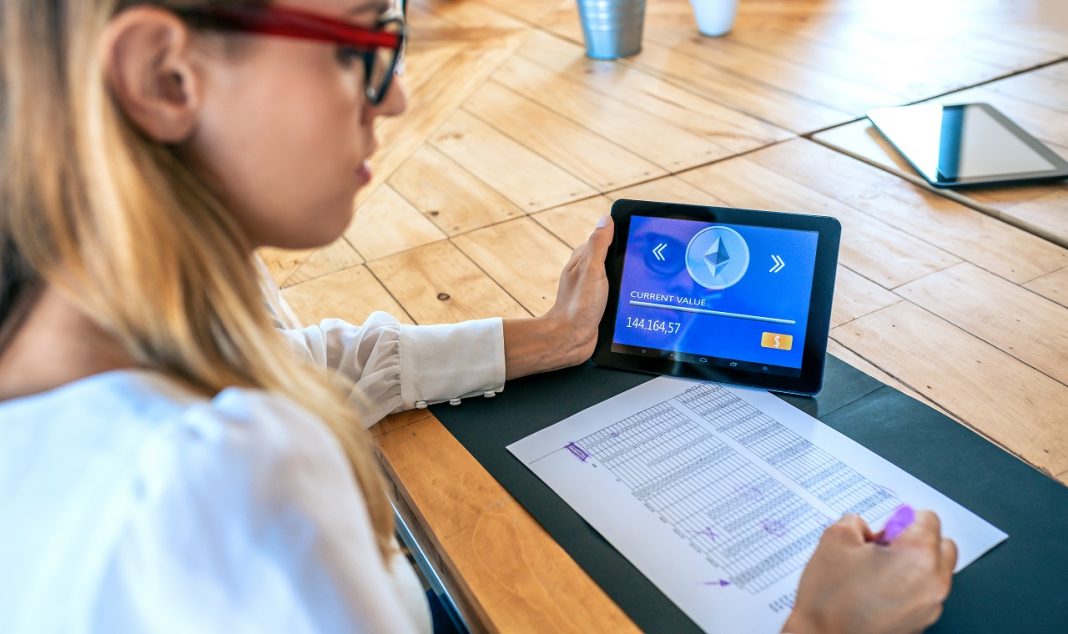 Businesswoman with tablet with ethereum information working