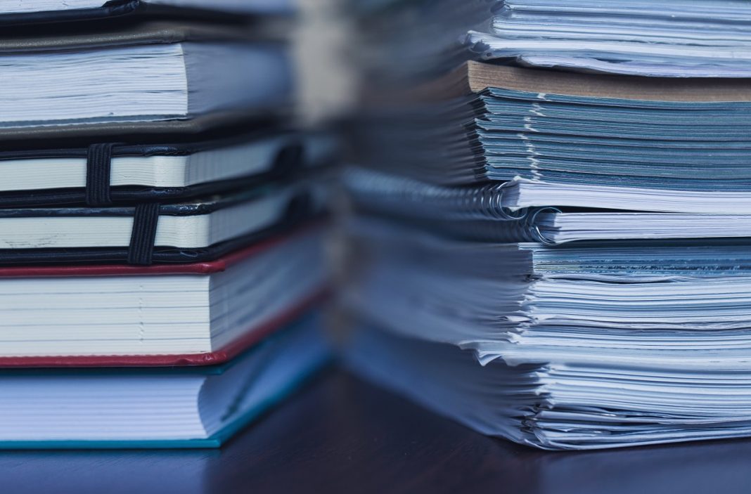 Accounting and taxes. Large pile of magazine and books