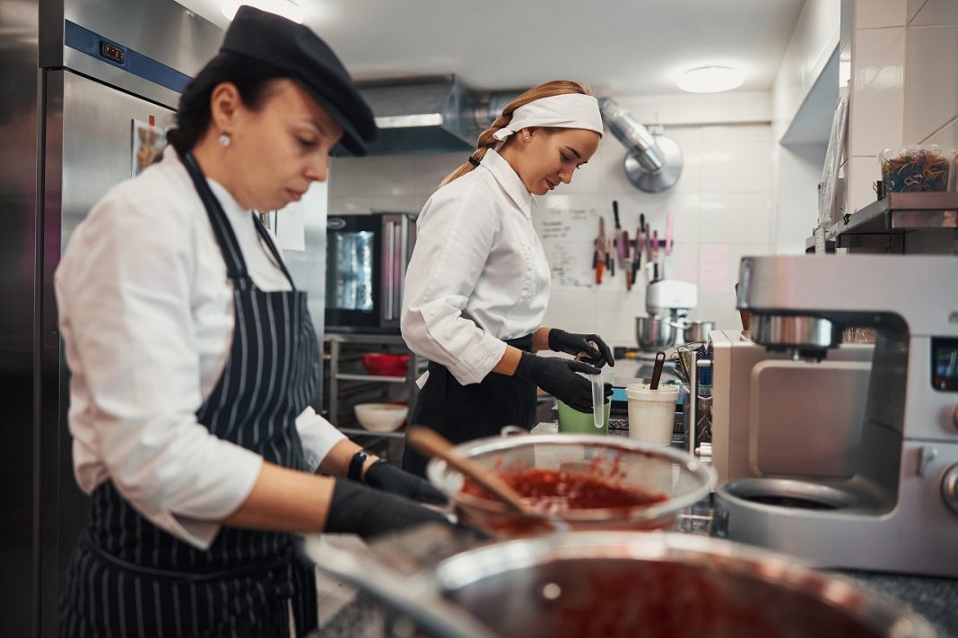 Chef and sous-chef performing great team work in the kitchen