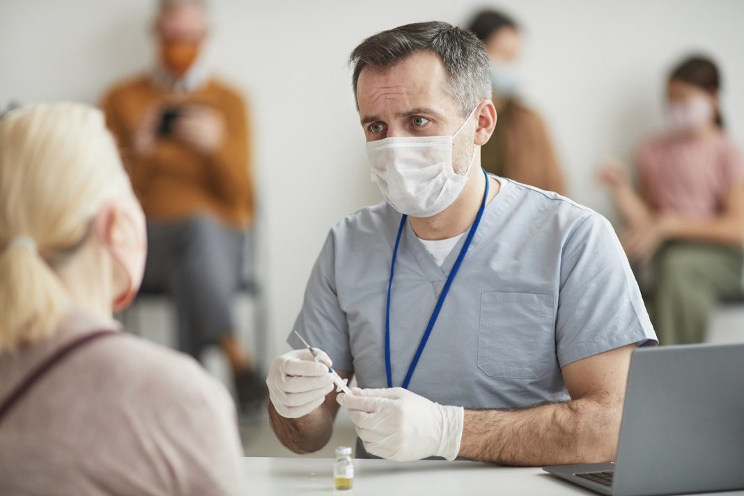 Doctor Consulting Patient at Vaccination