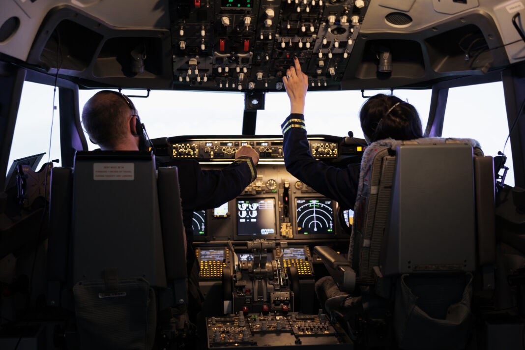 Captain and woman copilot getting ready to fly airplane